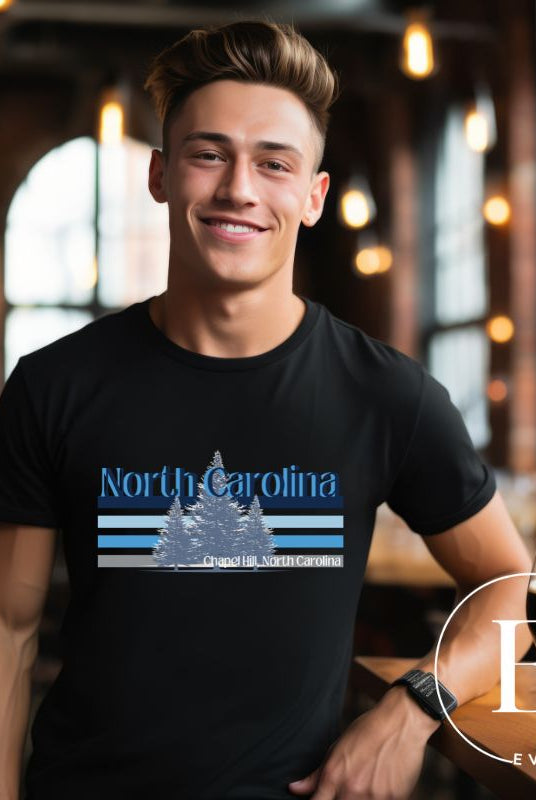 Show your school pride with this iconic North Carolina wordmark t-shirt. Made from premium materials, it features a North Carolina tree line in a the cool Carolina blue colors, representing a tradition of excellence for the nature that North Carolina offers on a black shirt. 