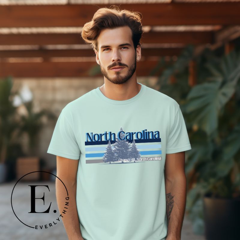 Show your school pride with this iconic North Carolina wordmark t-shirt. Made from premium materials, it features a North Carolina tree line in a the cool Carolina blue colors, representing a tradition of excellence for the nature that North Carolina offers on a mint shirt. 