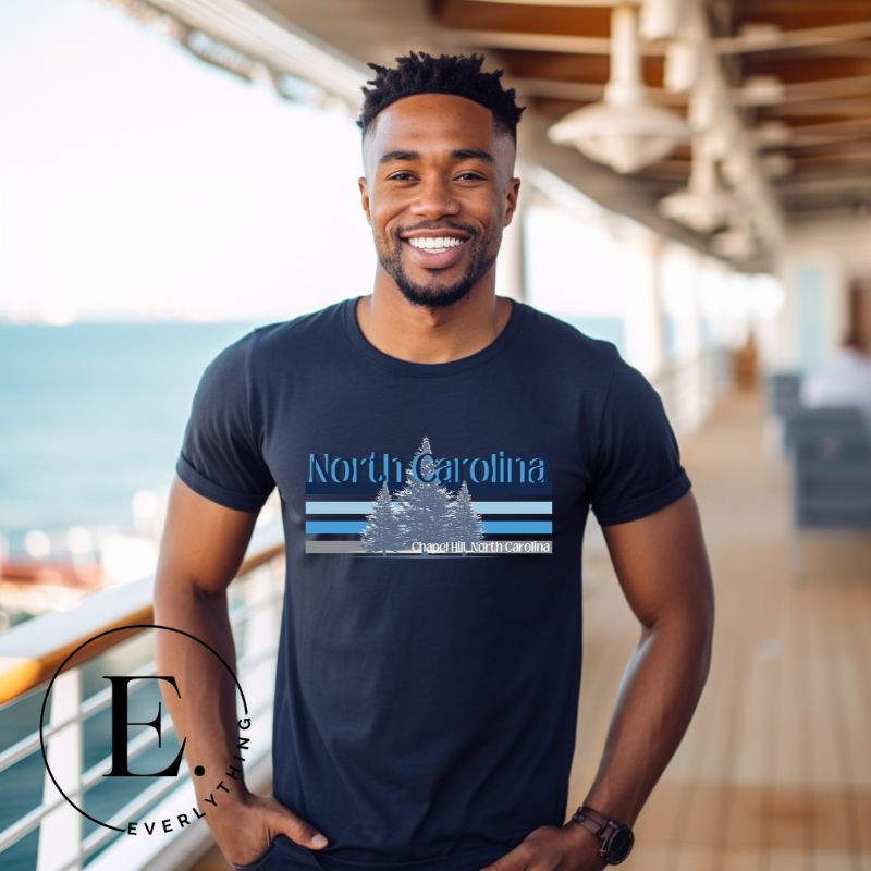 Show your school pride with this iconic North Carolina wordmark t-shirt. Made from premium materials, it features a North Carolina tree line in a the cool Carolina blue colors, representing a tradition of excellence for the nature that North Carolina offers on a navy shirt. 