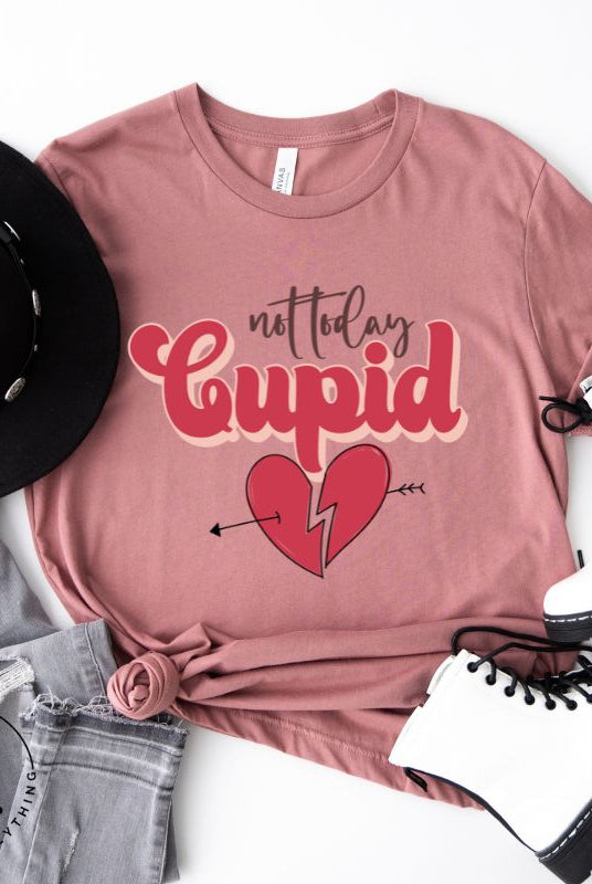 Spice up your Valentine's Day with our edgy shirt featuring a broken heart pierced by an arrow, and the defiant phrase "Not Today Cupid" on a mauve shirt. 