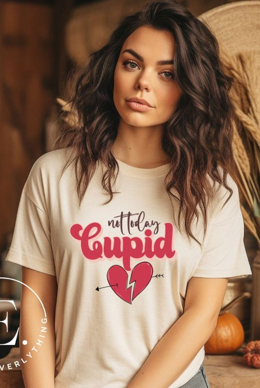Spice up your Valentine's Day with our edgy shirt featuring a broken heart pierced by an arrow, and the defiant phrase "Not Today Cupid" on a soft cream shirt. 