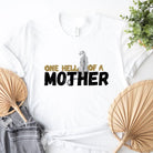 "One Hell of a Mother" Graphic Tee - The Ultimate Mama Shirt for Stylish Moms on a white shirt. 