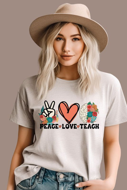 Floral design featuring the words 'peace love teach' on a teacher graphic tee - a great choice for teacher shirts and teacher gifts. White graphic tees.