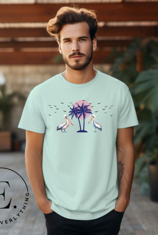 Elevate your beach style with our Beach shirt featuring two majestic pelicans facing each other. Set against a backdrop of a breathtaking sunset and a swaying palm tree on a mint shirt. 
