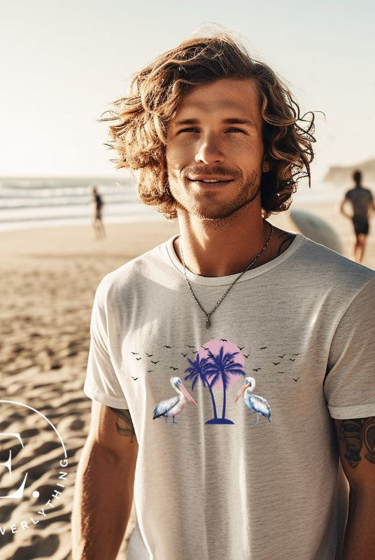 Elevate your beach style with our Beach shirt featuring two majestic pelicans facing each other. Set against a backdrop of a breathtaking sunset and a swaying palm tree on a grey shirt. 