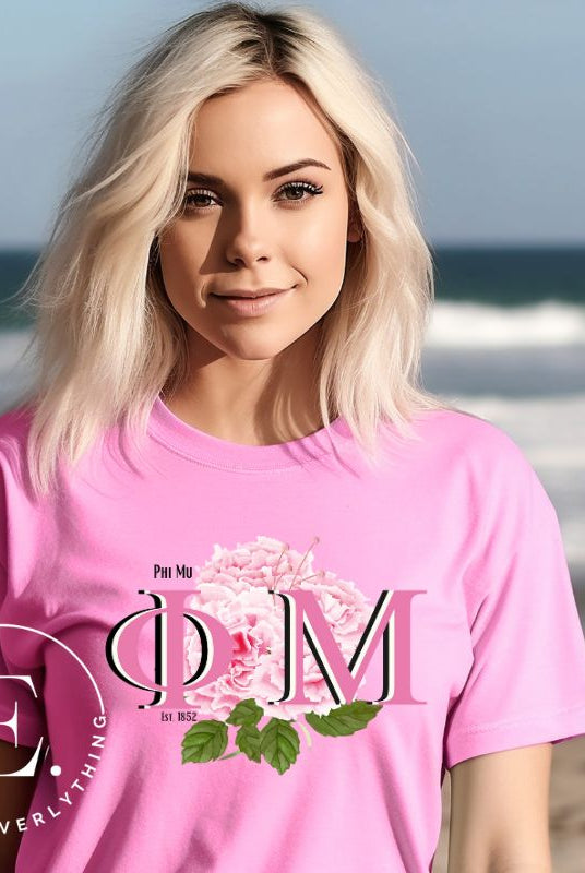 Looking for a stylish t-shirt to elevate your Phi Mu sisterhood? Our design features the sorority letters and beautiful pink carnations on a pink shirt. 