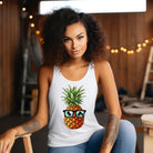 Women's racerback tank top in heather white featuring a graphic of a pineapple wearing sunglasses