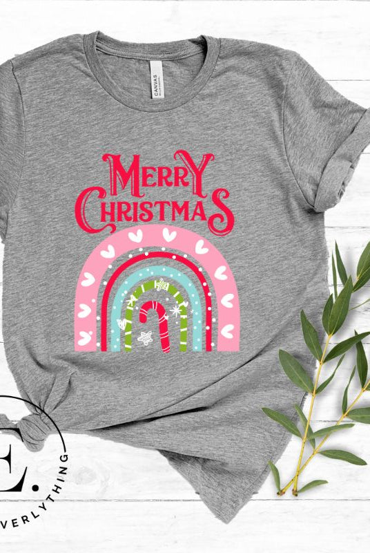Merry Christmas rainbow candy cane and heart tee on a white shirt on a grey shirt. 