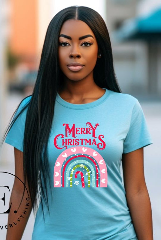 Merry Christmas rainbow candy cane and heart tee on a white shirt on a blue shirt. 