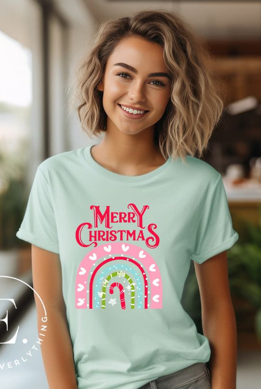 Merry Christmas rainbow candy cane and heart tee on a white shirt on a mint shirt. 