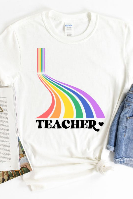 Colorful rainbow design with the word 'teacher' at the bottom, showcased on a teacher graphic tee. The perfect choice for teacher shirts and teacher gifts. White graphic tees.