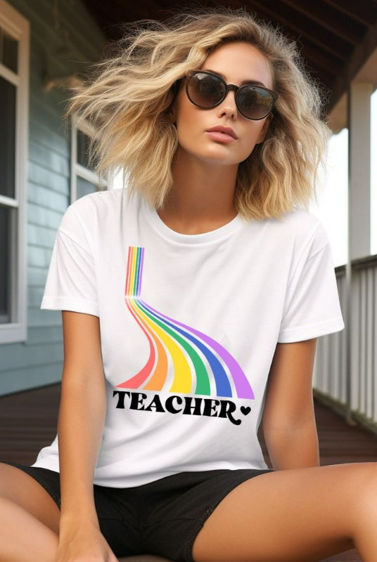 Colorful rainbow design with the word 'teacher' at the bottom, showcased on a teacher graphic tee. The perfect choice for teacher shirts and teacher gifts. White graphic tees.