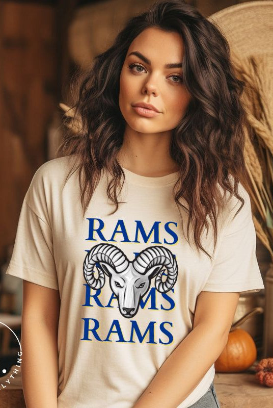 Unleash the Rams spirit with our Bella Canvas 3001 unisex tee! Elevate your game day style with the mantra 'Rams Rams Rams Rams' and a bold Rams head illustration on a soft cream shirt. 