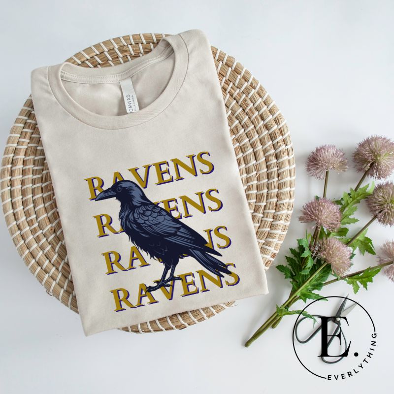 Fly high with our Bella Canvas 3001 unisex tee showcasing the spirited 'Ravens Ravens Ravens Ravens' design and a majestic Raven illustration on a dust colored shirt. 