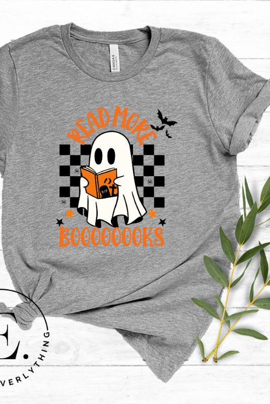 Get haunting stylish with our Halloween Ghost Reading t-shirt! Featuring a ghost engrossed in a book, it reads 'Read More Booooooks.' Perfect for bookworms and Halloween book enthusiasts on a grey shirt. 
