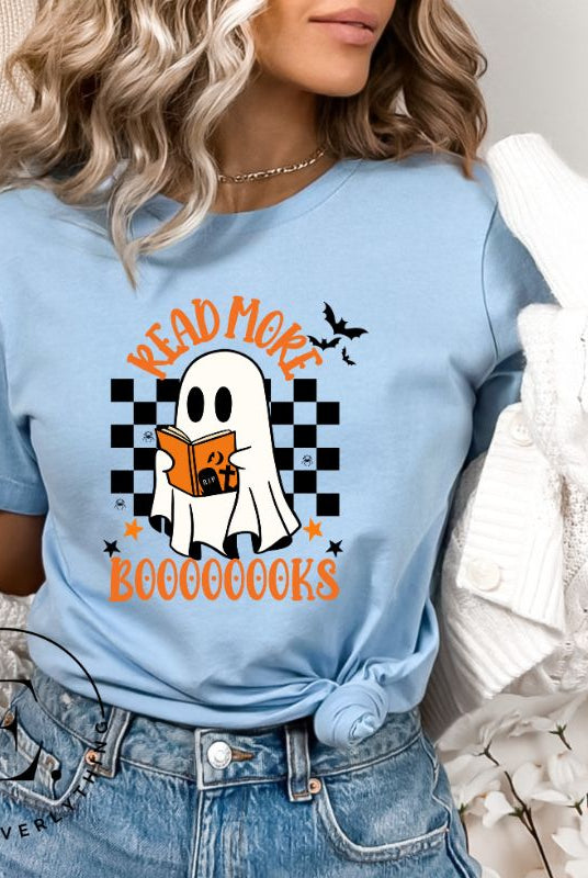 Get haunting stylish with our Halloween Ghost Reading t-shirt! Featuring a ghost engrossed in a book, it reads 'Read More Booooooks.' Perfect for bookworms and Halloween book enthusiasts on a blue shirt. 