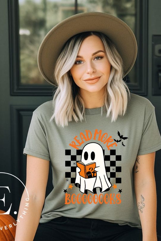 Get haunting stylish with our Halloween Ghost Reading t-shirt! Featuring a ghost engrossed in a book, it reads 'Read More Booooooks.' Perfect for bookworms and Halloween book enthusiasts on a green shirt. 