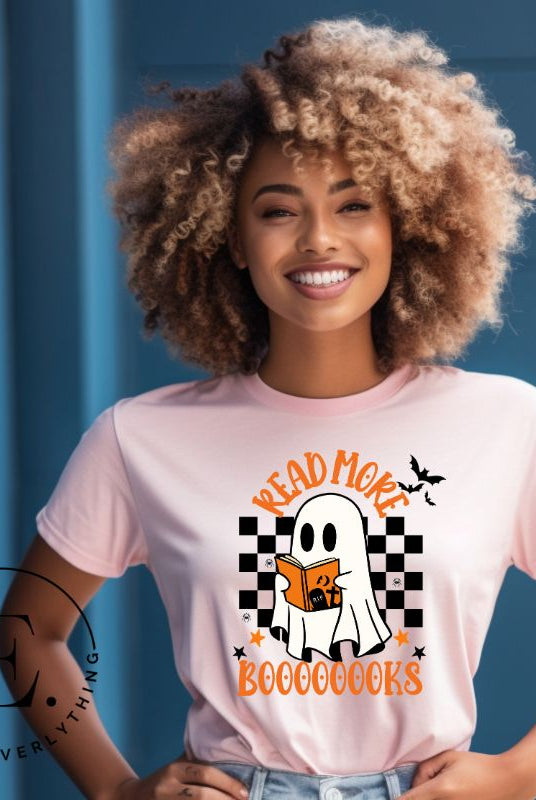 Get haunting stylish with our Halloween Ghost Reading t-shirt! Featuring a ghost engrossed in a book, it reads 'Read More Booooooks.' Perfect for bookworms and Halloween book enthusiasts on a pink shirt. 