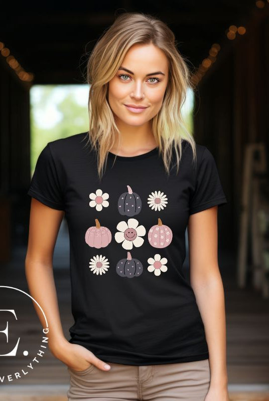 Step into retro autumn vibes with our trendy t-shirt. Featuring a delightful combination of pumpkins and retro flowers, on a black shirt. 