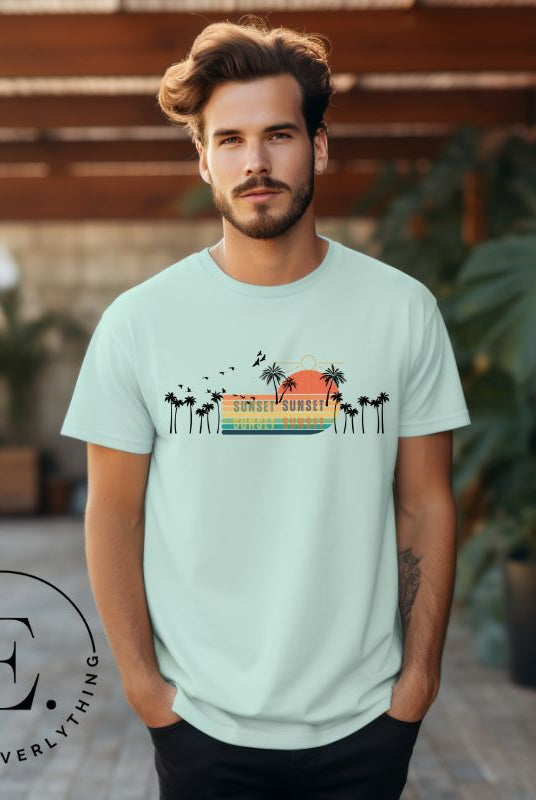 Transport yourself to a nostalgic beach getaway with our Retro Beach Shirt. Adorned with a captivating scene of a vintage sunset, palm trees, and seagulls soaring above on a mint shirt. 