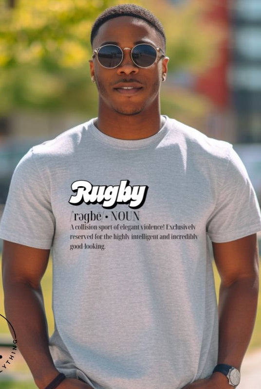 Introducing our Rugby Players Graphic T-Shirt - a perfect blend of humor, style, and a celebration of the game! This t-shirt features a witty definition that encapsulates the essence of rugby: "A collision sport of elegant violence! Exclusively reserved for the highly intelligent and incredibly good-looking," on a grey shirt. 