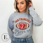 Show you allegiance to the San Francisco 49ers with this trendy sweatshirt, featuring a football and playful lips and tongue design. Emblazoned with the team's slogan "Faithful to the Bay" and the iconic San Francisco wordmark, on a grey sweatshirt. 