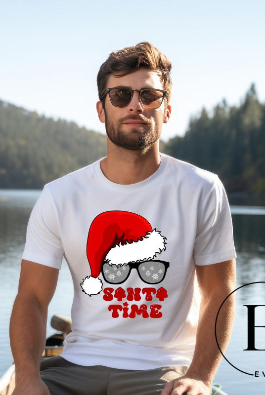 Gear up for the holiday season with our men's Christmas Shirt featuring a Santa hat, Christmas sunglasses on a white colored shirt. 