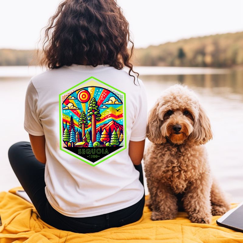 a colorful, detailed graphic of Sequoia National Park with the park's name and established year on the back, and a simplified text logo on the front on a white shirt.