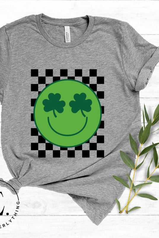 Get in the Saint Patrick's Day spirit with our Bella Canvas 3001 unisex graphic t-shirt! This unique design features a retro green smiley face with shamrock eyes, perfect for those seeking a festive and nostalgic look on a grey shirt. 