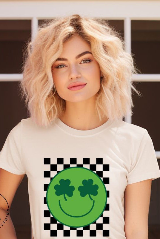 Get in the Saint Patrick's Day spirit with our Bella Canvas 3001 unisex graphic t-shirt! This unique design features a retro green smiley face with shamrock eyes, perfect for those seeking a festive and nostalgic look on a soft cream shirt.