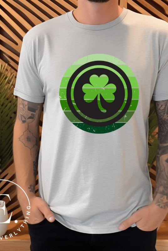 Get your ultimate Saint Patrick's Day attire with our Bella Canvas 3001 unisex graphic t-shirt! Featuring a captivating circle design in various shades of green, topped with a prominent shamrock, on a grey shirt. 