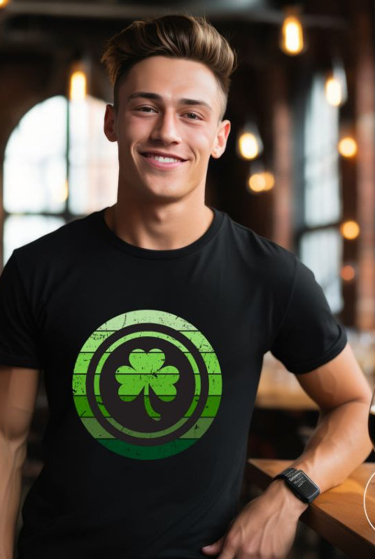 Get your ultimate Saint Patrick's Day attire with our Bella Canvas 3001 unisex graphic t-shirt! Featuring a captivating circle design in various shades of green, topped with a prominent shamrock, on a black shirt. 