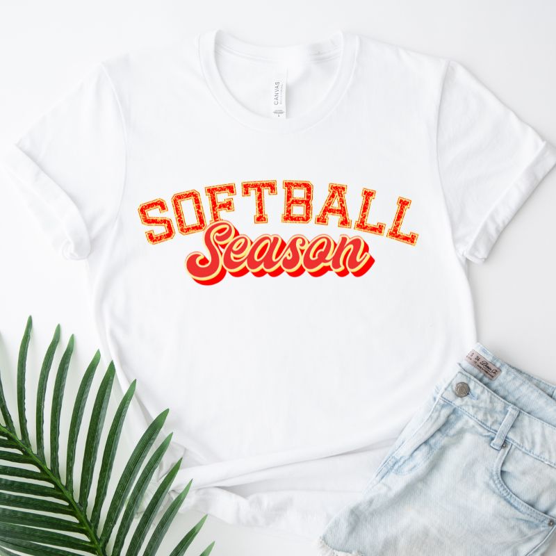 Softball Season Sports Lettering PNG Sublimation Digital Download Design, on a white graphic tee.