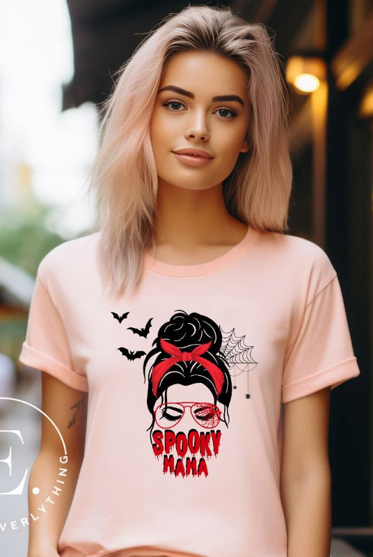 "Spooky Mama" messy bun Halloween T-shirt on pink colored t-shirt.