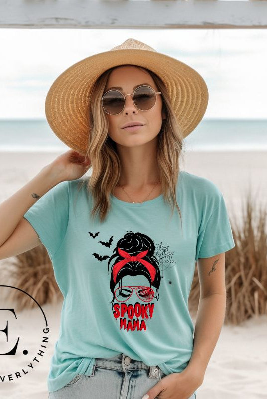 "Spooky Mama" messy bun Halloween T-shirt on teal colored t-shirt.