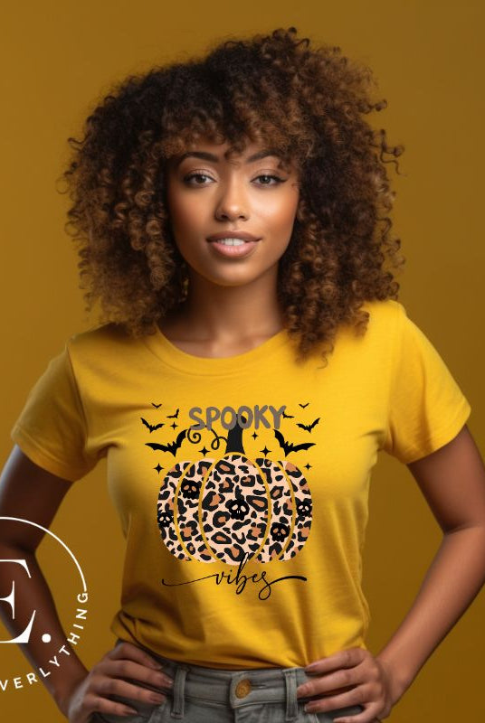 Get into Halloween spirit with our spooky vibes shirt featuring a unique cheetah print pumpkin adorned with skulls. As bats soar across the starry sky, embrace the eerie charm of this one-of-a-kind design on a yellow shirt. 