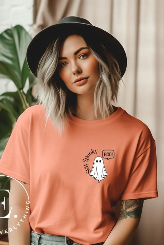 Get into the Halloween spirit with our spooktacular t-shirt. Featuring a friendly ghost holding a sign that says 'Boo' and the playful phrase "Stay Spooky"  on a peach shirt. 