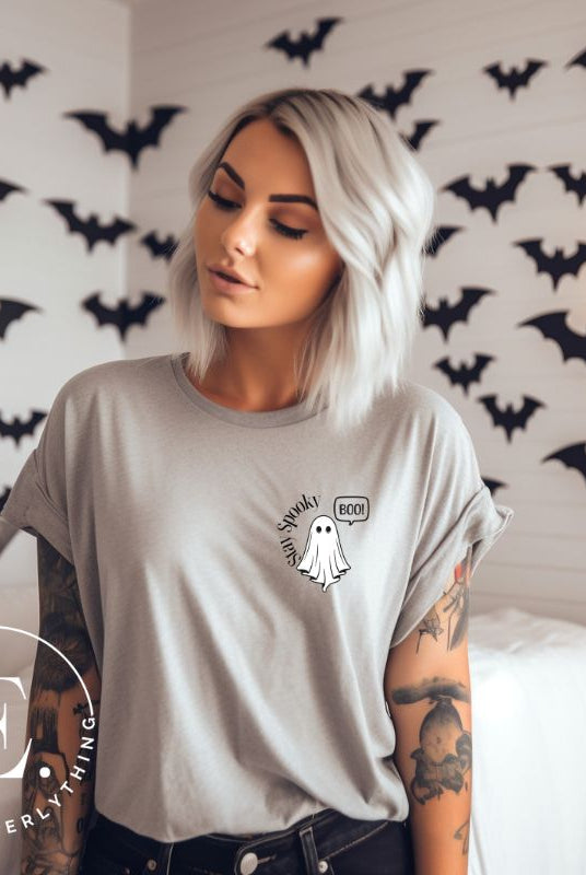 Get into the Halloween spirit with our spooktacular t-shirt. Featuring a friendly ghost holding a sign that says 'Boo' and the playful phrase "Stay Spooky"  on a grey shirt. 