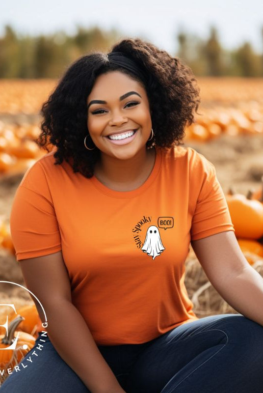 Get into the Halloween spirit with our spooktacular t-shirt. Featuring a friendly ghost holding a sign that says 'Boo' and the playful phrase "Stay Spooky"  on an orange shirt. 