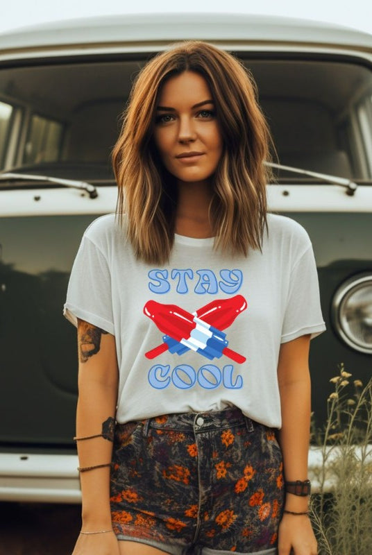 A fun and playful graphic tee for the USA July 4th celebration featuring vibrant and colorful bomb popsicles with the text 'Stay Cool' on the front. The tee captures the essence of summertime and the festive spirit of July 4th, making it a perfect choice for a cool and refreshing look on a white graphic tee.