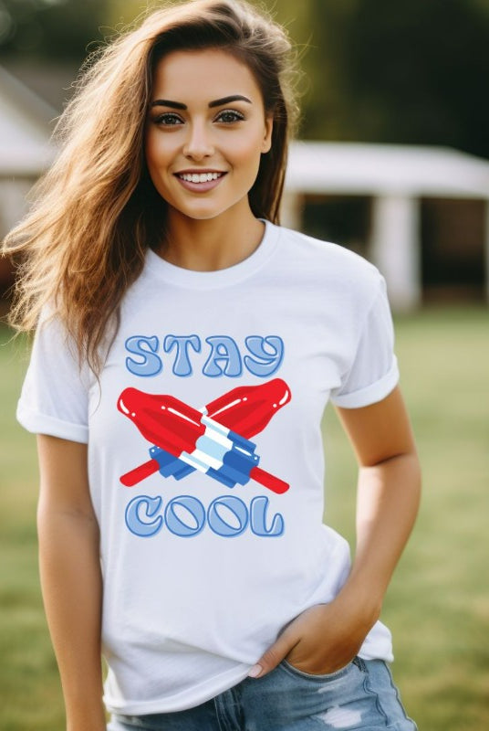 A fun and playful graphic tee for the USA July 4th celebration featuring vibrant and colorful bomb popsicles with the text 'Stay Cool' on the front. The tee captures the essence of summertime and the festive spirit of July 4th, making it a perfect choice for a cool and refreshing look on a white graphic tee.