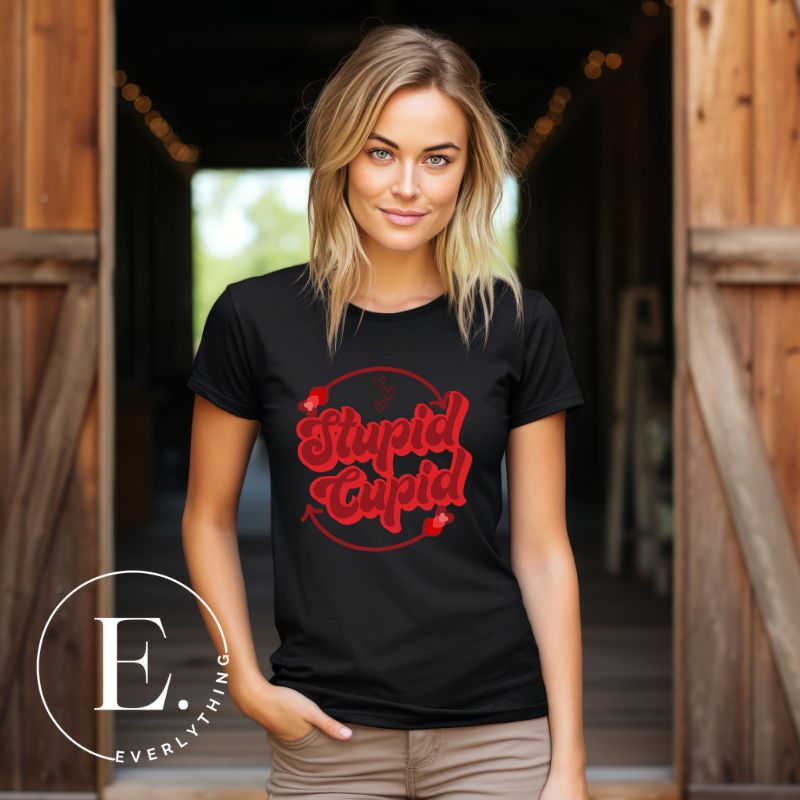 Express your Valentine's Day attitude with our bold and cheeky shirt proclaiming "Stupid Cupid" on a black shirt. 