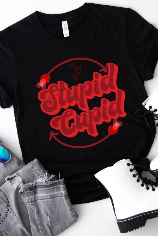 Express your Valentine's Day attitude with our bold and cheeky shirt proclaiming "Stupid Cupid" on a black shirt. 