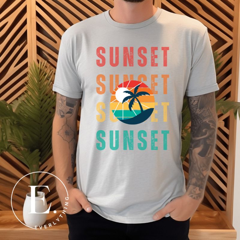 Capture the essence of tropical paradise with our Sunset t-shirt. Featuring four rows of the word 'sunset' surrounding a stunning palm tree on a grey shirt. 