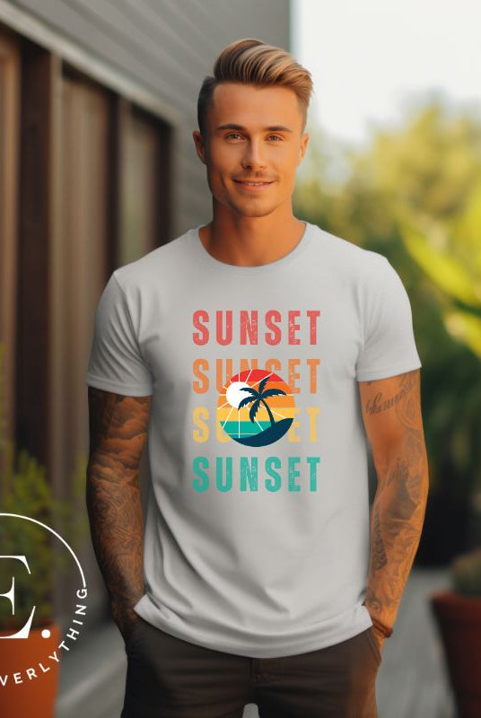 Capture the essence of tropical paradise with our Sunset t-shirt. This shirt features four rows of the word 'sunset' surrounding a stunning palm tree, bringing a laid-back, beachy vibe to your wardrobe with this grey shirt. 