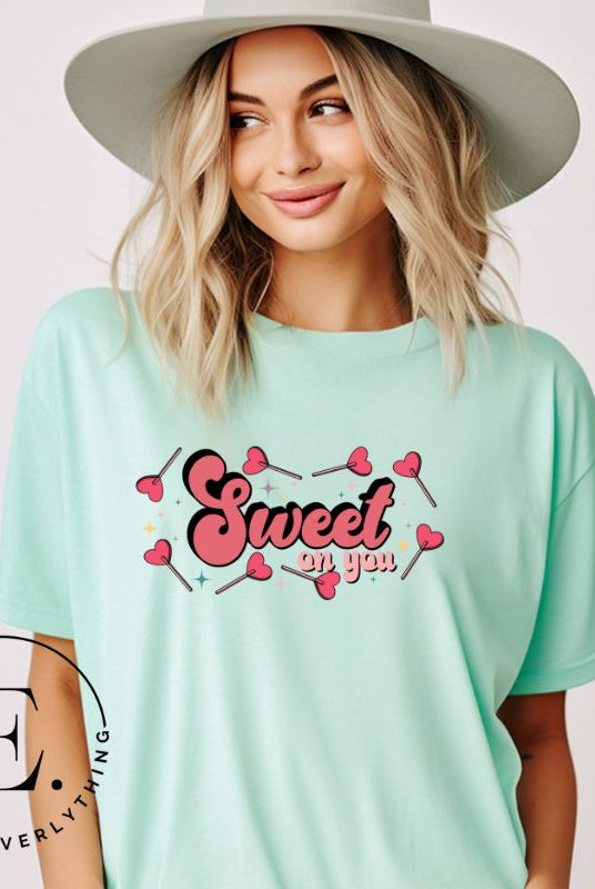 Spread the love with our charming Valentine's Day shirt featuring the endearing phrase " Sweet on You" surrounded by heart lollipops on a mint shirt. 