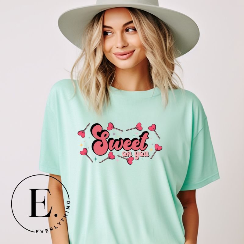 Spread sweetness this Valentine's Day with our PNG sublimation digital download! Create an adorable shirt adorned with heart lollipops and the charming saying "Sweet On You." Example of Sweet On You PNG sublimation digital download on a mint shirt. 