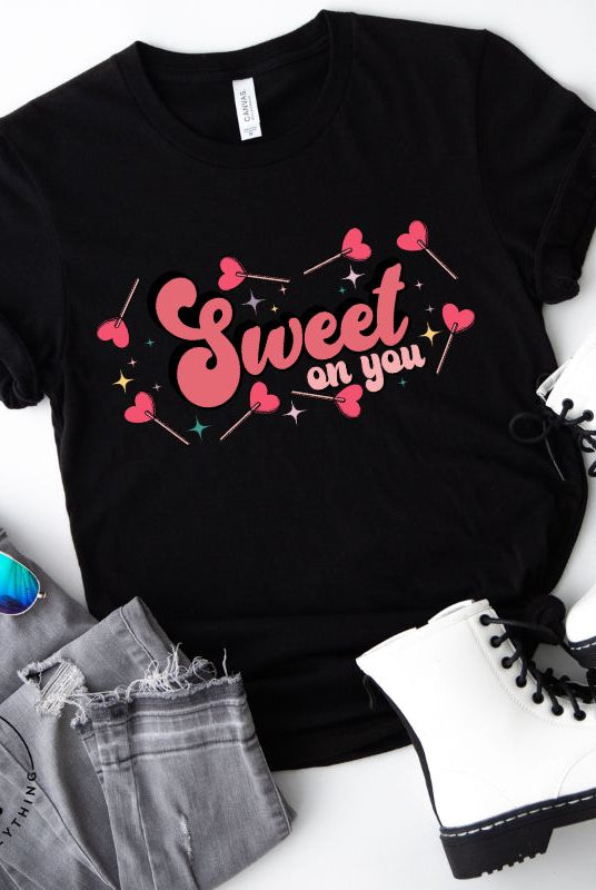 Spread the love with our charming Valentine's Day shirt featuring the endearing phrase " Sweet on You" surrounded by heart lollipops on a black shirt. 