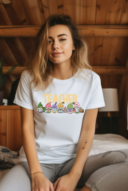 White teacher graphic tee featuring adorable teacher gnomes and the word 'teacher' - perfect for teacher shirts and teacher gifts. Available in black and white graphic tees.