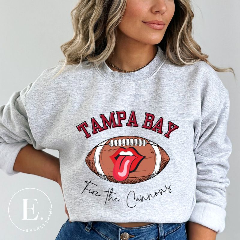 Get ready to showcase your support for the Tampa Bay Buccaneers with this eye-catching sweatshirt. Featuring a football and playful lips and tongue design, it proudly displays the team's rallying cry "Fire the Cannons" and the distinctive Tampa Bay wordmark grey sweatshirt. 